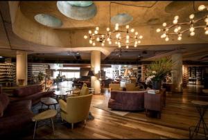 a lobby with couches and chairs in a library at Apartment nestled between Lake Burley Griffin, city and ANU in Canberra
