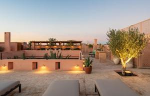 a rooftop patio with a restaurant on a building at Riad Dar Al Dall - This Time Tomorrow in Marrakech in Marrakesh