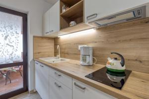 a kitchen with a tea kettle on a counter at Nettes Appartement in Rovinj mit Garten, Terrasse und Grill in Rovinj