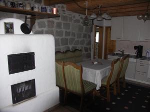 a kitchen with a table and chairs and a stove at Ferienwohnung im Bayerischen Wald für 5 Personen in Kollnburg