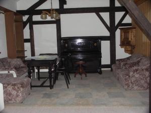 ein Wohnzimmer mit einem Klavier und einem Tisch in der Unterkunft Ferienwohnung im Bayerischen Wald für 5 Personen in Kollnburg