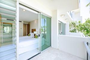 a room with a glass door leading to a bedroom at The Platinum Luxury Villa ~ Walk to Beach, Village in Sunshine Beach +25 photos