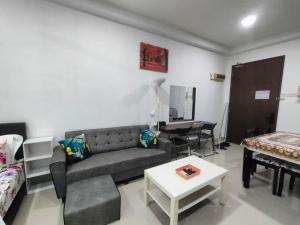 a living room with a couch and a table at Cozy Stay at Shaftsburry, Urban Convenience #SH1 in Cyberjaya