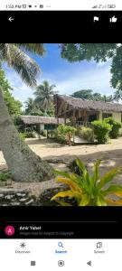 a picture of a house with a tree at White Beach Bungalow & Restaurant in Lénakel