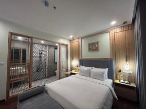 a bedroom with a large bed and a bathroom at Grand Hotel HN- by BAY LUXURY in Hanoi +6 photos