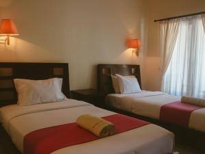 Postel nebo postele na pokoji v ubytování New Puri Asih Hotel + 14 fotografií