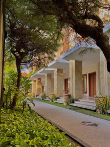 a view of a building with trees in front of it at New Puri Asih Hotel in Kuta