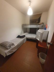 a small room with two bunk beds in it at de paso Alcobendas in Alcobendas