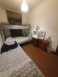 a bedroom with two bunk beds and a tv at de paso Alcobendas in Alcobendas