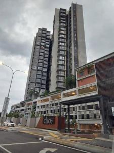 two tall buildings in a city with a street at Modern 7-Pax Retreat Steps from IOI City Mall in Serdang