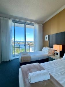 een hotelkamer met 2 bedden en een groot raam bij Chevron Renaissance - Resort Style Living by Gold Coast Premium in Gold Coast