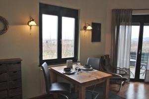 a dining room with a wooden table and chairs at Appartement in Sasbach Am Kaiserstuhl mit Grill in Sasbach am Kaiserstuhl