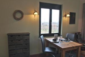 a room with a wooden table and a window at Appartement in Sasbach Am Kaiserstuhl mit Grill in Sasbach am Kaiserstuhl