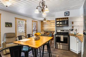 a kitchen and dining room with a table and chairs at Big Fern Cabin in Vanderpool