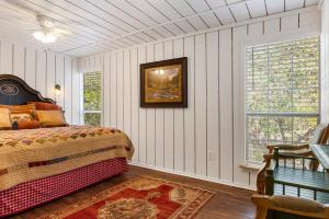 a bedroom with a bed and a picture on the wall at Big Fern Cabin in Vanderpool