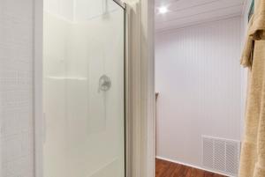 a shower with a glass door in a bathroom at Big Fern Cabin in Vanderpool