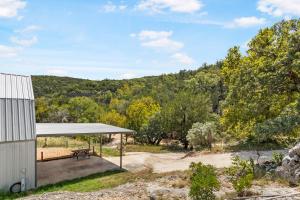 a pavilion with a bench in front of a mountain at Big Fern Cabin in Vanderpool