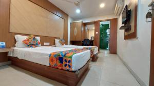 a bedroom with two beds in a room at Hotel Park Resort Bhubaneswar Couple Friendly in Bhubaneshwar