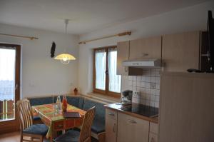 uma cozinha com uma mesa e uma sala de jantar em Wohnung in Meransen em Maranza