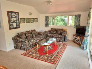 a living room with a couch and a coffee table at Arles Historical Homestead in Whanganui