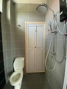 a bathroom with a toilet and a shower at HOMESTAY ACIK in Kampong Tanjong Gelam