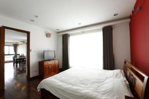 a bedroom with a bed and a large window at Davidduc's Service Apartment - Xom Chua in Hanoi