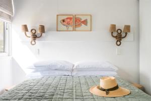 a hat is sitting on top of a bed at Seaspray Yeppoon in Yeppoon