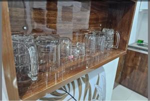 a row of glass jars sitting on a counter at Darshana Studios#Cozy in Noida