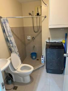 a small bathroom with a toilet and a sink at Elegant 2 Bedroom Unit @Avida#27 in Iloilo City