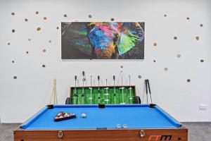 a pool table in a room with a picture of an elephant at King’s Deluxe in Newtown in Sydney