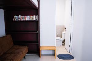 ein Wohnzimmer mit Sofa und Bücherregal in der Unterkunft Brownies House in Bandung