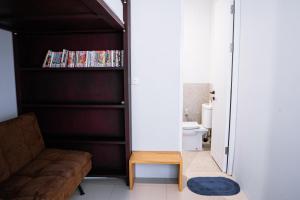a living room with a couch and a book shelf at Brownies House in Bandung
