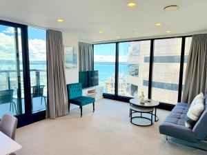 a living room with a couch and a tv at Magnificent SkyTower, Sea, Habour View in CBD in Auckland