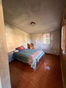 a bedroom with a bed in the corner of a room at Cabaña Mi Pequeño Paraíso in Cuernavaca +51 photos