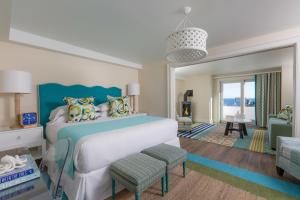 a bedroom with a bed and a living room at The Break Hotel in Narragansett +37 photos