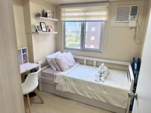 a small bedroom with a bed and a window at Stay comfy & feel Homealike #32 in Iloilo City