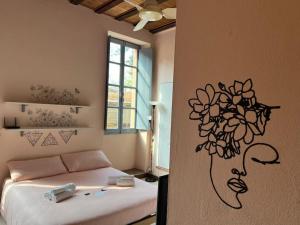 a bedroom with a bed with a flower on the wall at Minimal Studio con travi a vista in Piacenza