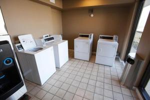 a room with four washing machines in a room at Ocean Reef Suites in Kill Devil Hills