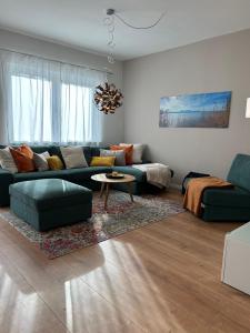 a living room with a couch and a table at Ferienhaus Baron mit eigener Sauna in Marquartstein