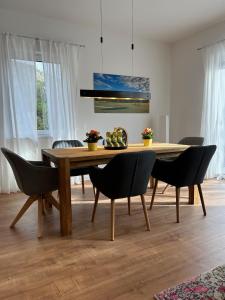 a dining room with a wooden table and chairs at Ferienhaus Baron mit eigener Sauna in Marquartstein