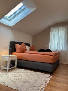 a bedroom with a bed and a skylight at Ferienhaus Baron mit eigener Sauna in Marquartstein