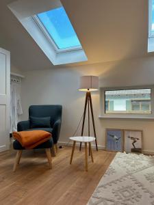 a living room with a skylight and a chair and a table at Ferienhaus Baron mit eigener Sauna in Marquartstein