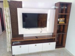 a tv on top of a entertainment center at RRRHomestay in Tirupati