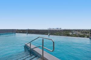 una piscina con un pasamanos en el agua en Generous 2-Bed Apartment with Great Amenities, en Melbourne