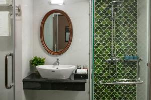 ein Bad mit einem Waschbecken und einem Spiegel in der Unterkunft Eliana Premio Hotel Hanoi in Hanoi