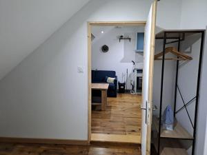 an open door to a living room with a table at T2 / 24h du Mans / Circuit / Karting / Antares / Boulerie Jump / Stade de foot in Le Mans