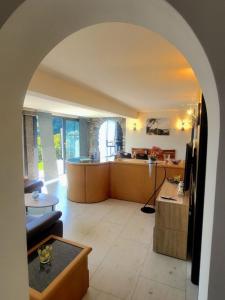 an archway of a living room and a kitchen at Casa Moorea - b44923 in Brione sopra Minusio