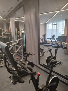 a gym with a bunch of exercise bikes in it at 1 Bedroom Suite - Brand New building, Double bed in Hamilton