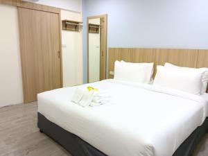 Postel nebo postele na pokoji v ubytování Beyond 21 Hotel