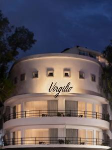 a large white building with a sign on it at Kimpton Virgilio in Mexico City